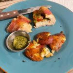 Bacon wrapped, pesto and roma tomato stuffed chicken with smashed potatoes and p…