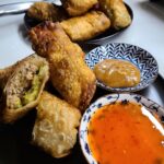 Egg rolls 

Ground pork 
Shallots 
Garlic 
Cilantro 
Red curry paste

Wrapped in…