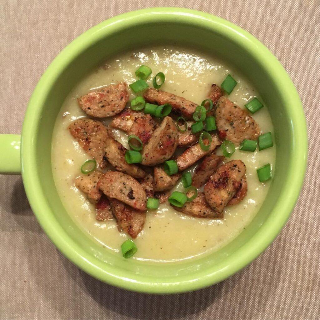 Paleo creamy potato leek soup from  topped with browned chicken sausage and chiv…