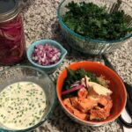 Salmon, kale, and quinoa bowls with a creamy citrus dressing and pickled red oni…