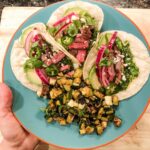 Seared medium rare steak tacos with chimichurri, cotjia cheese, quick pickled re…